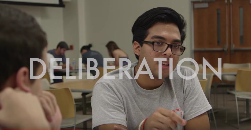 an image of a boy with glasses is covered by the word DELIBERATION