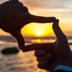 Image of hands framing the sun on the cover of the From the Editor article