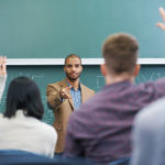 Shot of a young male teacher giving a lesson to his students on the lecture hall