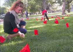 Volunteers plant red flags in the community